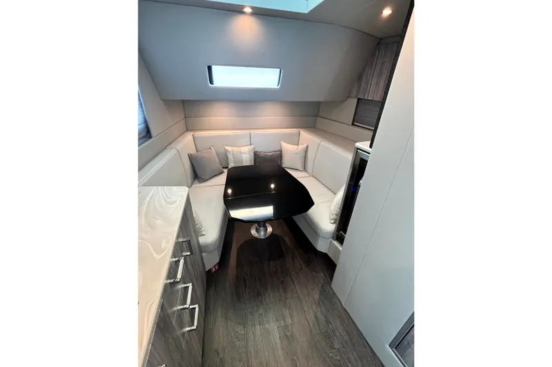 Slide: The Image of Luxurious interior of 2025 Formula 500 Super Sport Crossover with modern seating and sleek table. - 28