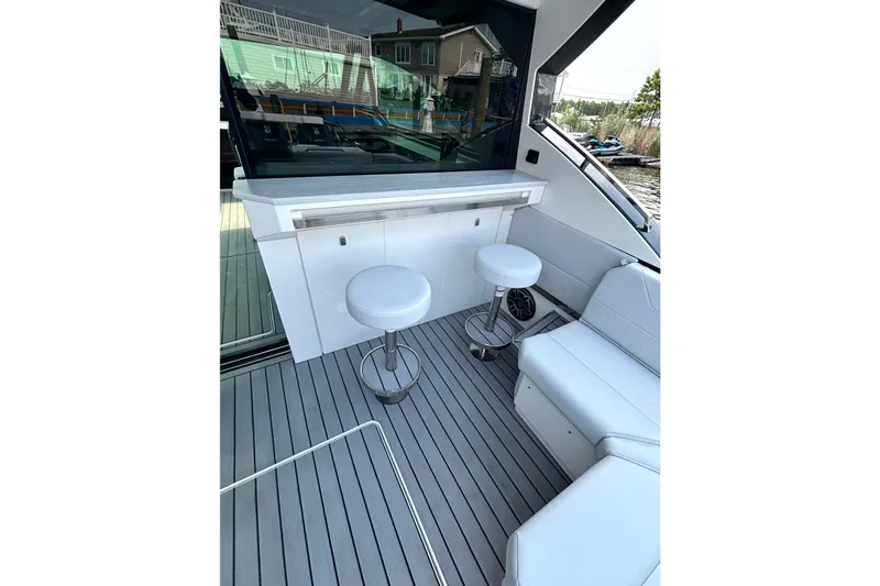 Slide: The Image of Luxurious interior of 2025 Formula 500 Super Sport Crossover yacht with sleek seating and bar stools. - 21