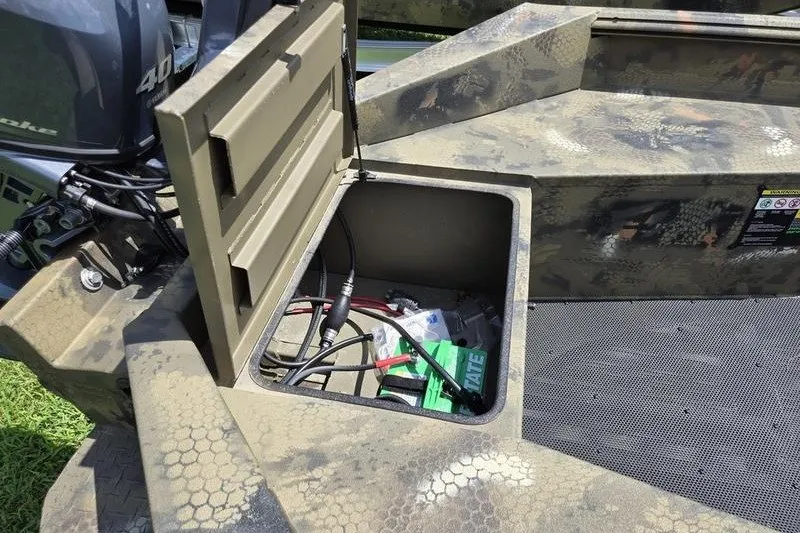 Slide: The Image of Open storage compartment in 2026 Havoc 1553 VJST boat, revealing battery and wiring. - 9
