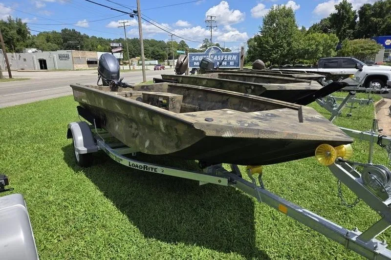 Slide: The Image of 2026 Havoc 1553 VJST boat on trailer, camo design, parked on grass under blue sky. - 5