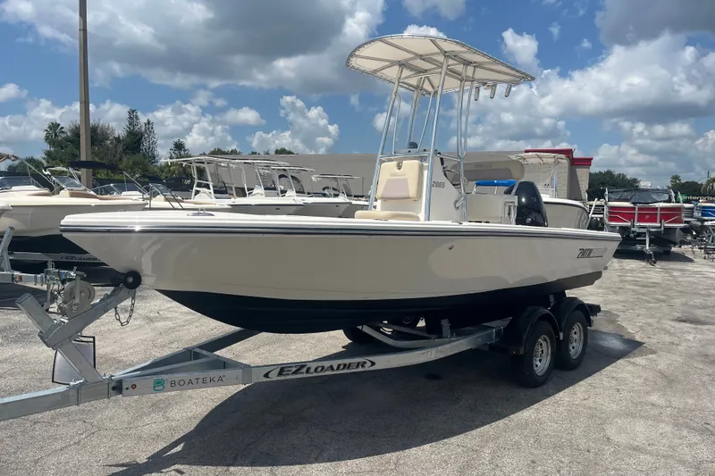 Slide: The Image of Pathfinder 2005 TRS boat on EZ Loader trailer under blue sky, 2023 model. - 10
