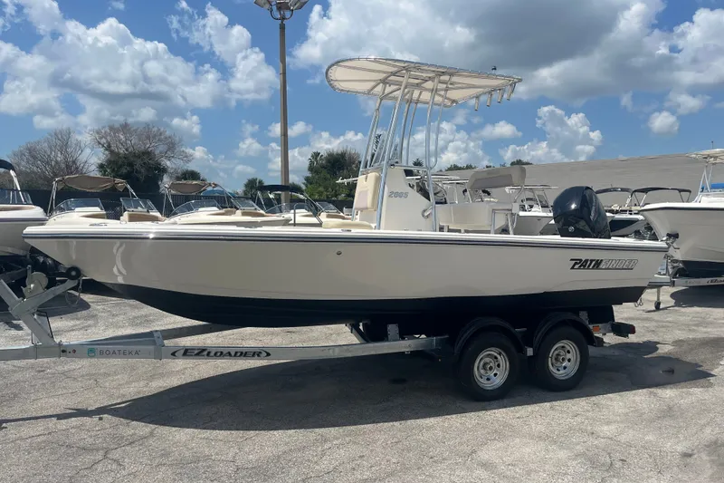 Slide: The Image of Pathfinder 2005 TRS boat on EZ Loader trailer, sunny day, 2023 model. - 11