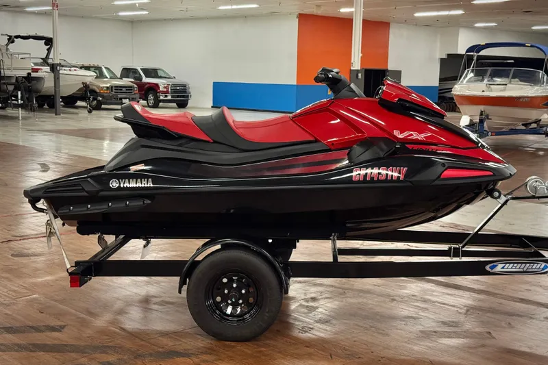 Slide: The Image of 2024 Yamaha WaveRunner VX Limited in showroom, red and black design on trailer. - 3