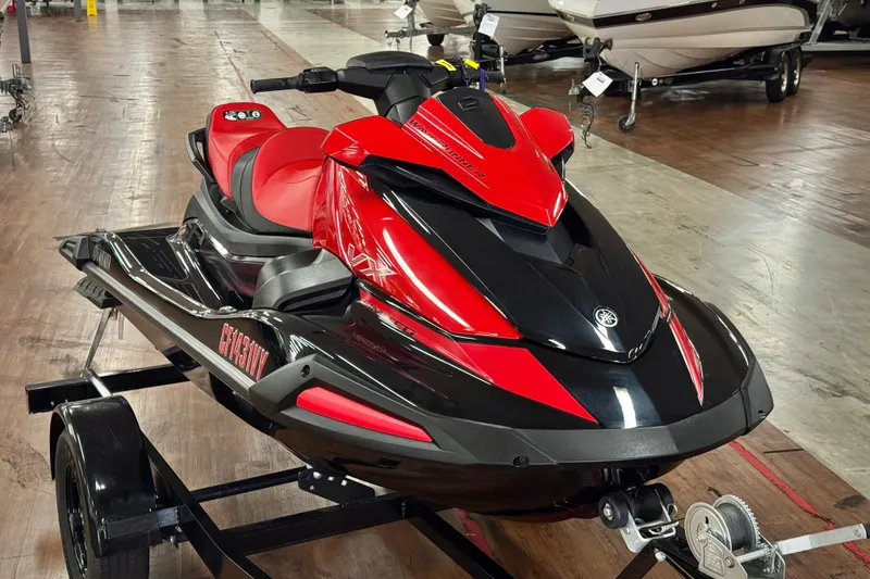Slide: The Image of 2024 Yamaha WaveRunner VX Limited in red and black on a trailer indoors. - 2