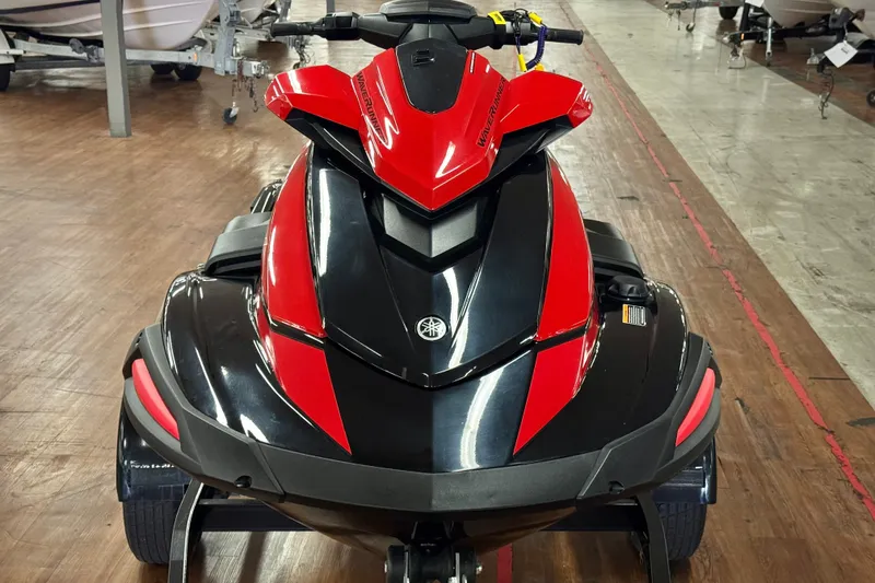 Slide: The Image of 2024 Yamaha WaveRunner VX Limited in red and black on display indoors. - 1