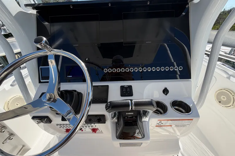 Slide: The Image of 2020 Edgewater 262CC boat dashboard with steering wheel and control panel. - 10