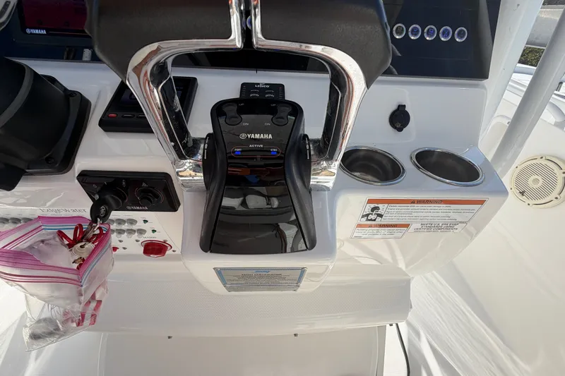 Slide: The Image of Edgewater 262CC 2020 boat console with Yamaha controls and cup holders. - 11