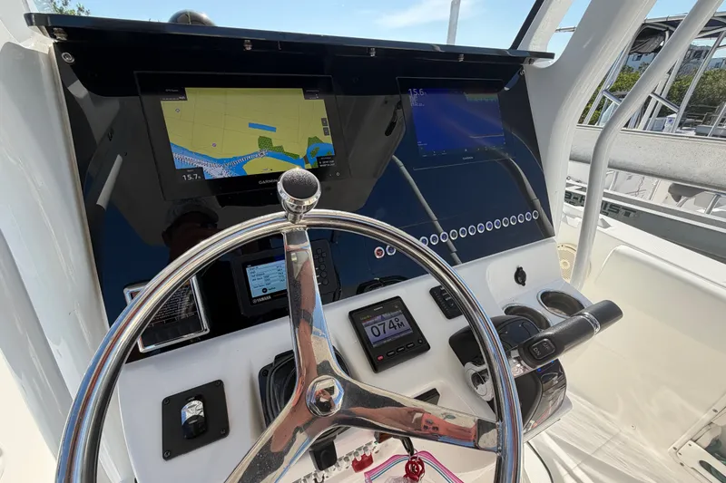 Slide: The Image of Edgewater 262CC 2020 boat dashboard with navigation screens and steering wheel. - 8