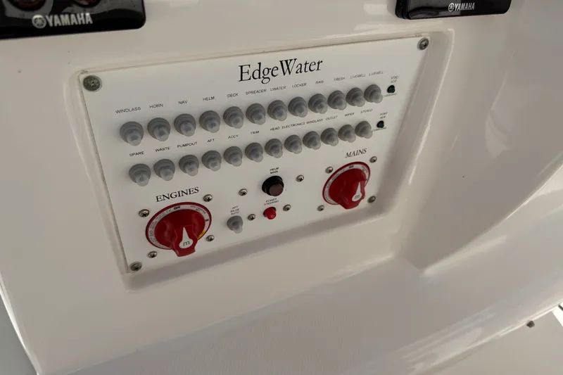 Slide: The Image of Control panel of a 2020 Edgewater 262CC boat with labeled switches and dials. - 25