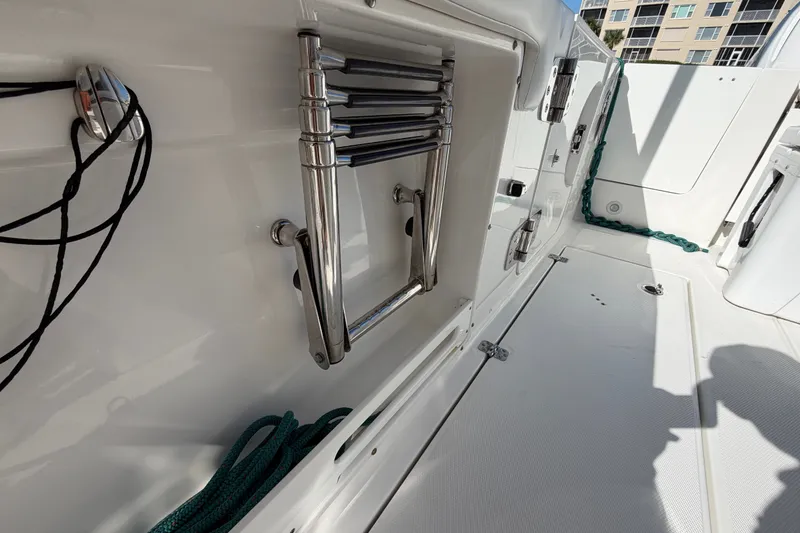 Slide: The Image of 2020 Edgewater 262CC boat interior with stainless steel ladder and storage compartments. - 20
