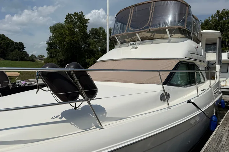 Slide: The Image of 1997 Sea Ray 370 Aft Cabin yacht docked, featuring sleek design and spacious upper deck. - 7