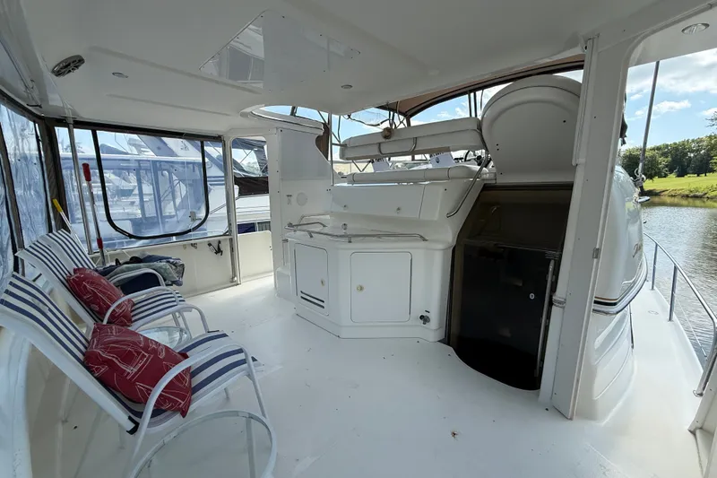 Slide: The Image of 1997 Sea Ray 370 Aft Cabin yacht interior with seating and water view. - 14