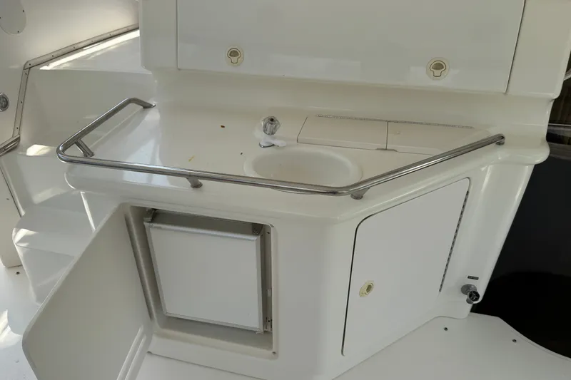 Slide: The Image of 1997 Sea Ray 370 Aft Cabin yacht kitchenette with sink and storage. - 17