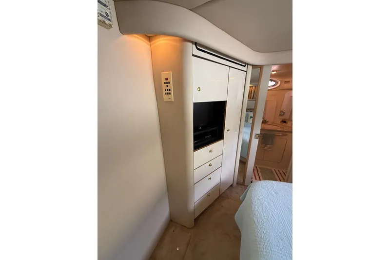 Slide: The Image of Interior of 1997 Sea Ray 370 Aft Cabin with built-in storage and TV. - 45