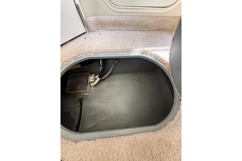 Slide: The Image of 1997 Sea Ray 370 Aft Cabin interior compartment with carpeted steps and visible wiring. - 40