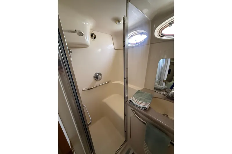 Slide: The Image of Shower area in 1997 Sea Ray 370 Aft Cabin yacht with towels and porthole window. - 47