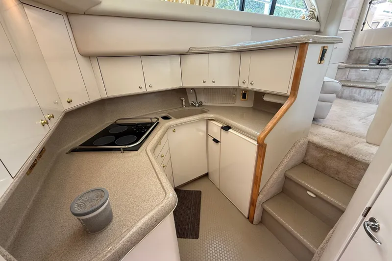 Slide: The Image of 1997 Sea Ray 370 Aft Cabin yacht kitchen with modern appliances and ample storage. - 31