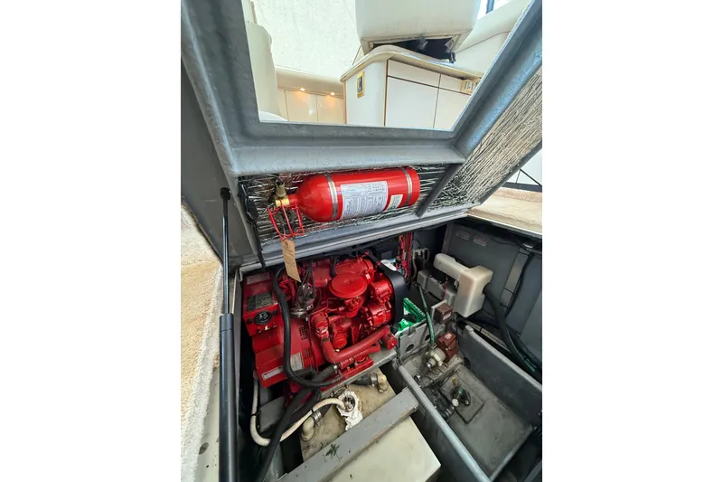Slide: The Image of Engine compartment of 1997 Sea Ray 370 Aft Cabin with fire extinguisher and red engine. - 53