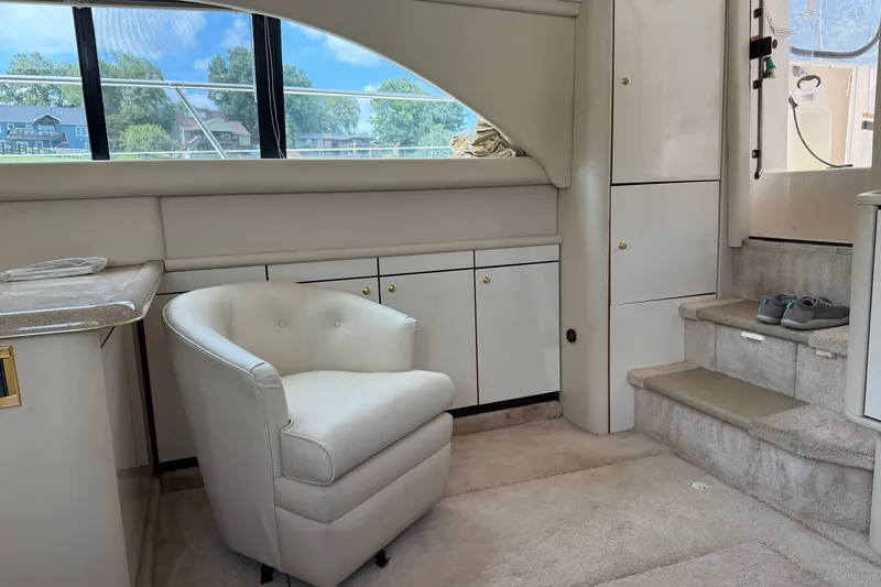 Slide: The Image of Interior of a 1997 Sea Ray 370 Aft Cabin yacht with plush seating and cabinetry. - 27