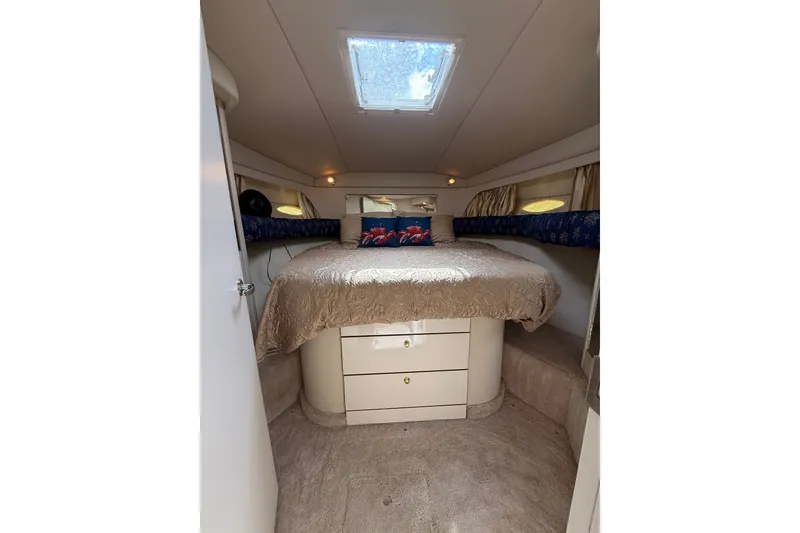 Slide: The Image of Interior cabin of 1997 Sea Ray 370 Aft Cabin yacht, featuring a cozy bed and storage. - 34
