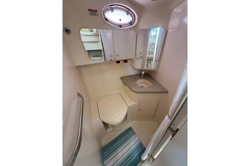 Slide: The Image of 1997 Sea Ray 370 Aft Cabin bathroom with compact design, sink, and toilet. - 39
