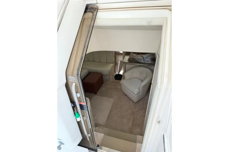 Slide: The Image of Interior view of 1997 Sea Ray 370 Aft Cabin with beige seating and carpet. - 25