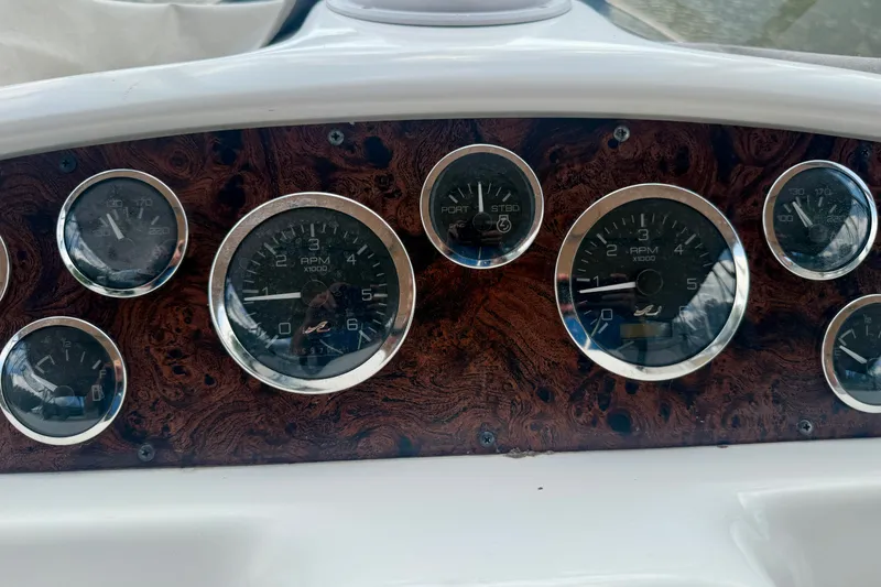 Slide: The Image of Dashboard of a 1997 Sea Ray 370 Aft Cabin boat with multiple gauges. - 22