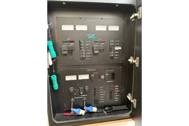 Slide: The Image of Electrical panel of a 1997 Sea Ray 370 Aft Cabin boat, showing switches and meters. - 49