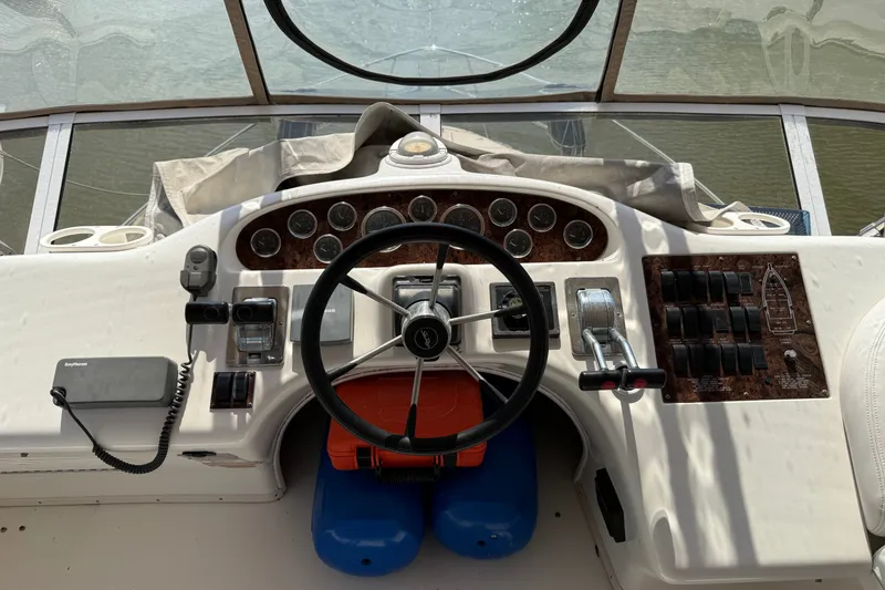 Slide: The Image of Cockpit of 1997 Sea Ray 370 Aft Cabin with steering wheel and control panel. - 21