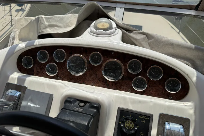 Slide: The Image of Dashboard of a 1997 Sea Ray 370 Aft Cabin boat with gauges and controls. - 24
