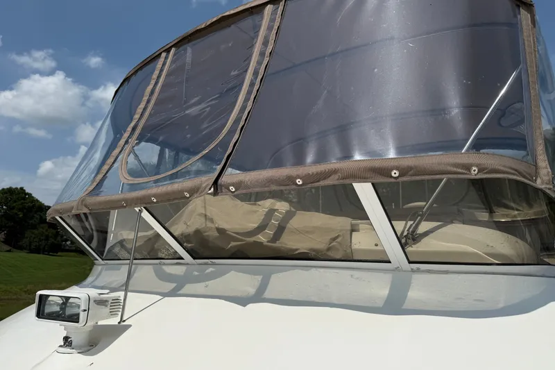 Slide: The Image of 1997 Sea Ray 370 Aft Cabin boat with clear canopy under blue sky. - 13