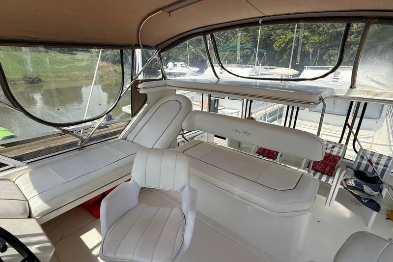 Slide: The Image of 1997 Sea Ray 370 Aft Cabin interior with white seating and panoramic windows. - 19