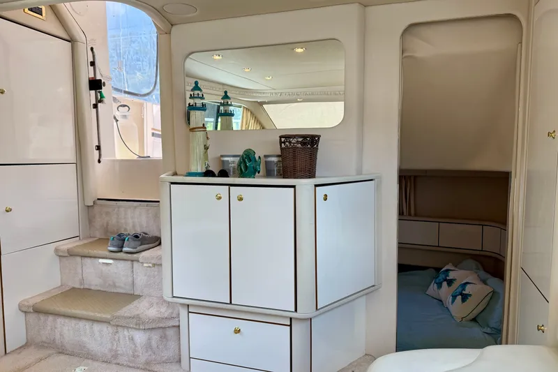Slide: The Image of Interior of 1997 Sea Ray 370 Aft Cabin with elegant cabinetry and cozy sleeping area. - 42
