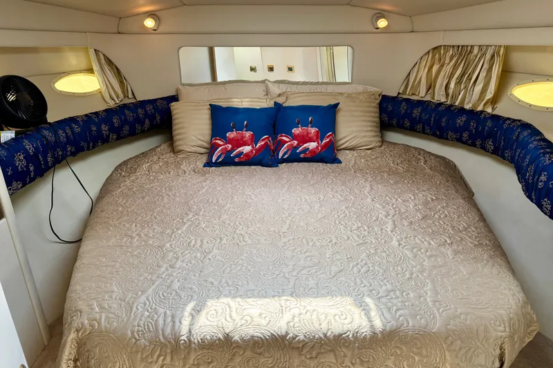 Slide: The Image of Cozy bedroom in 1997 Sea Ray 370 Aft Cabin with nautical-themed decor. - 35