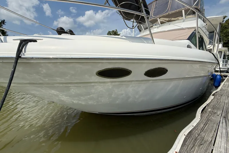 Slide: The Image of 1997 Sea Ray 370 Aft Cabin yacht docked, showcasing sleek design and white exterior. - 9