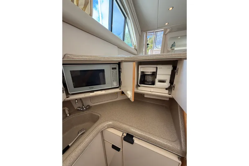 Slide: The Image of 1997 Sea Ray 370 Aft Cabin kitchen with microwave and coffee maker. - 32