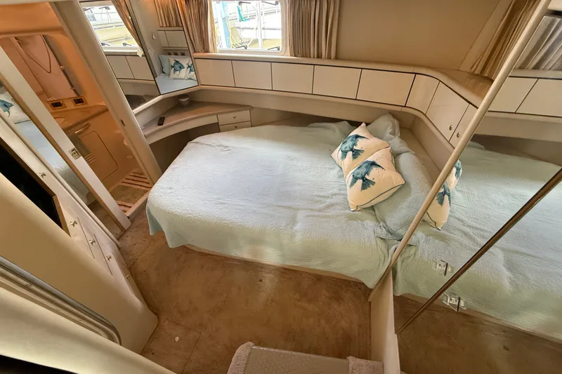 Slide: The Image of Cozy bedroom in 1997 Sea Ray 370 Aft Cabin yacht with nautical-themed decor. - 43
