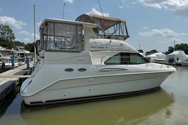 Slide: The Image of 1997 Sea Ray 370 Aft Cabin yacht docked at marina under clear skies. - 3