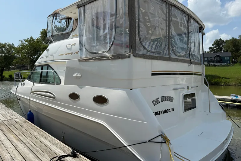Slide: The Image of 1997 Sea Ray 370 Aft Cabin yacht docked by a wooden pier on a sunny day. - 6