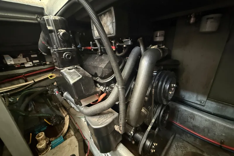 Slide: The Image of Engine compartment of a 1997 Sea Ray 370 Aft Cabin boat, showcasing mechanical components. - 55