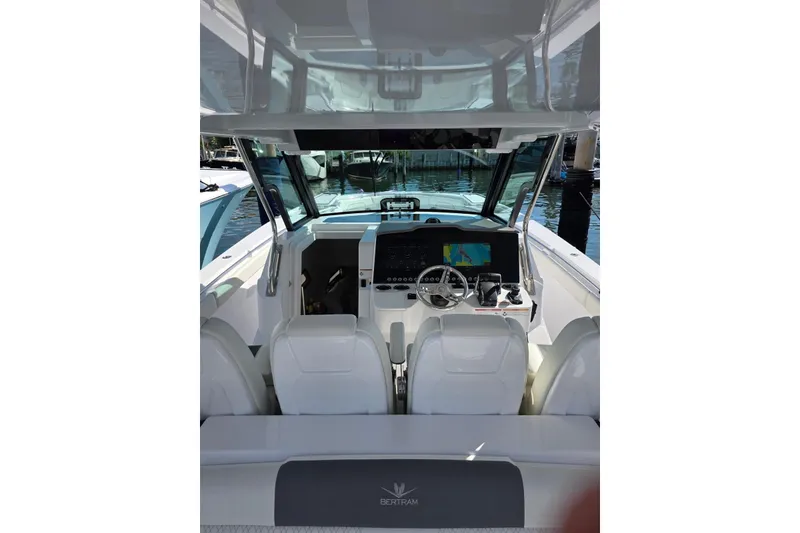 Slide: The Image of 2025 Bertram 39 CC boat cockpit with modern navigation system and sleek design. - 4