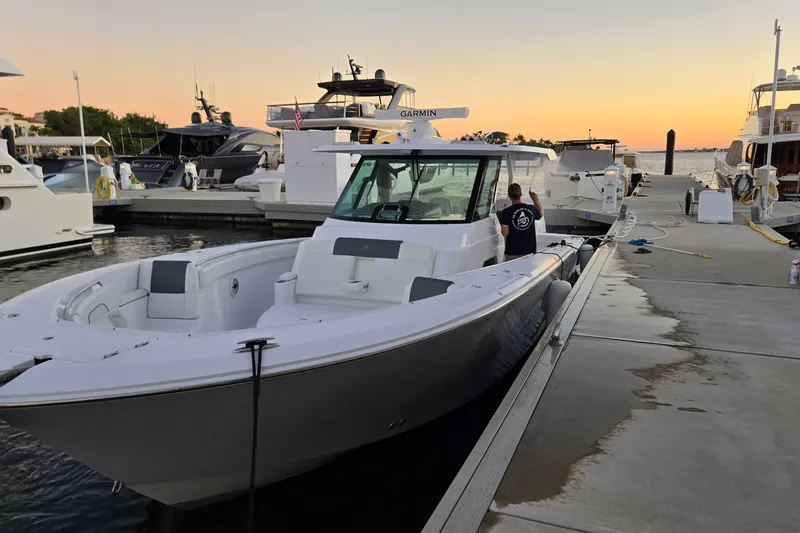 The Image of 2025 Bertram 39 CC boat docked at marina during sunset. - 1