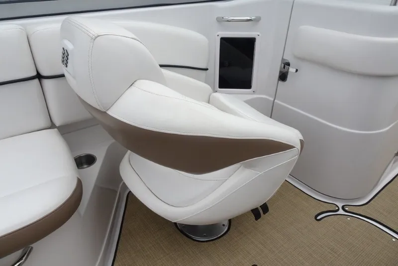 Slide: The Image of White and brown captain's chair on 2008 Four Winns H260 boat interior. - 20