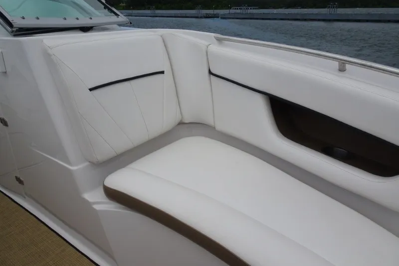 Slide: The Image of White seating area on a 2008 Four Winns H260 boat by the water. - 26