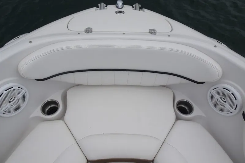 Slide: The Image of 2008 Four Winns H260 boat interior with white seating and built-in speakers. - 24