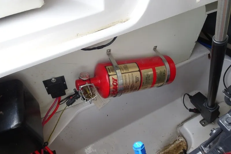 Slide: The Image of Fire extinguisher mounted in 2008 Four Winns H260 boat compartment. - 30