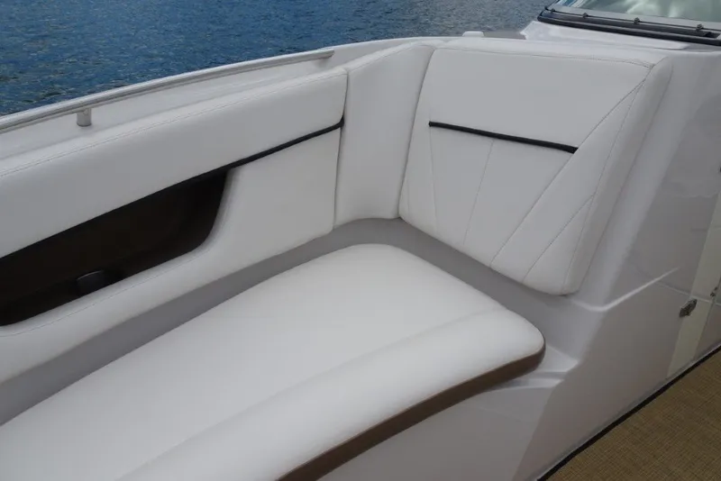 Slide: The Image of 2008 Four Winns H260 boat interior with white cushioned seating by the water. - 27