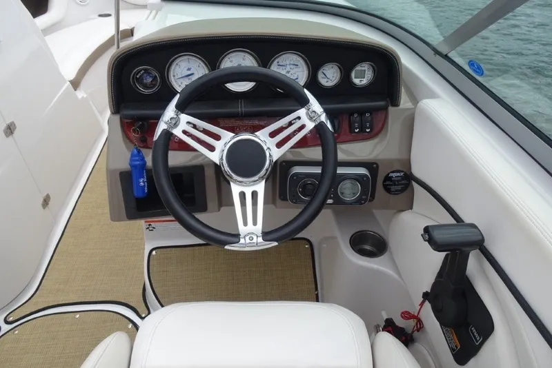 Slide: The Image of 2008 Four Winns H260 boat dashboard with steering wheel and instrument panel. - 15
