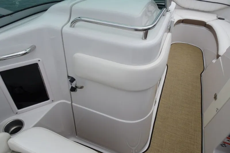 Slide: The Image of Interior view of a 2008 Four Winns H260 boat, featuring seating and a carpeted floor. - 21