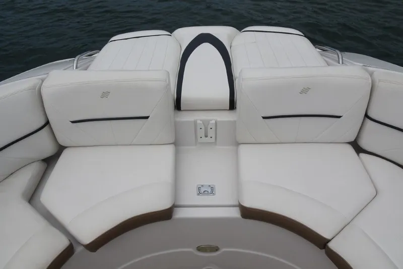 Slide: The Image of 2008 Four Winns H260 boat interior with white cushioned seating and water backdrop. - 28